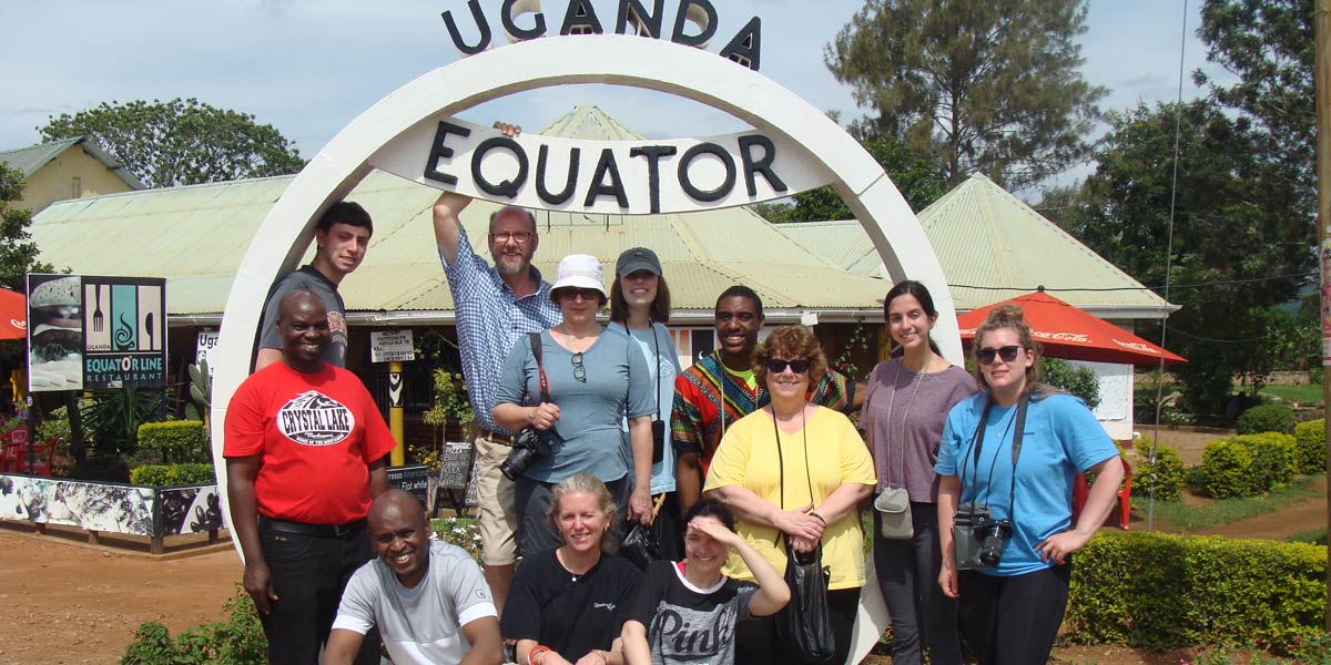 group of people in front of equator sign